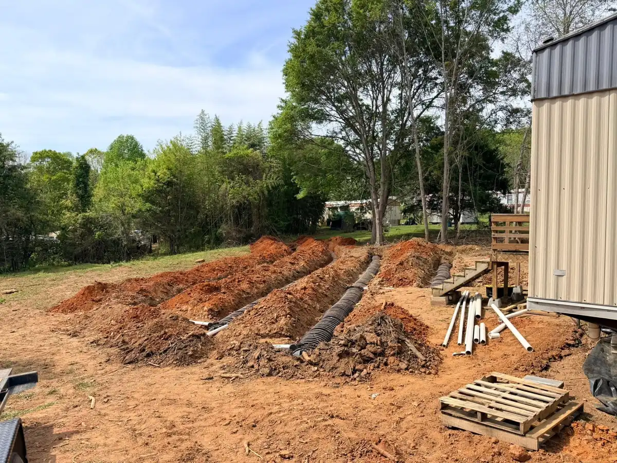 Drain field lines run beside a home during a septic system install in Cleveland County, NC
