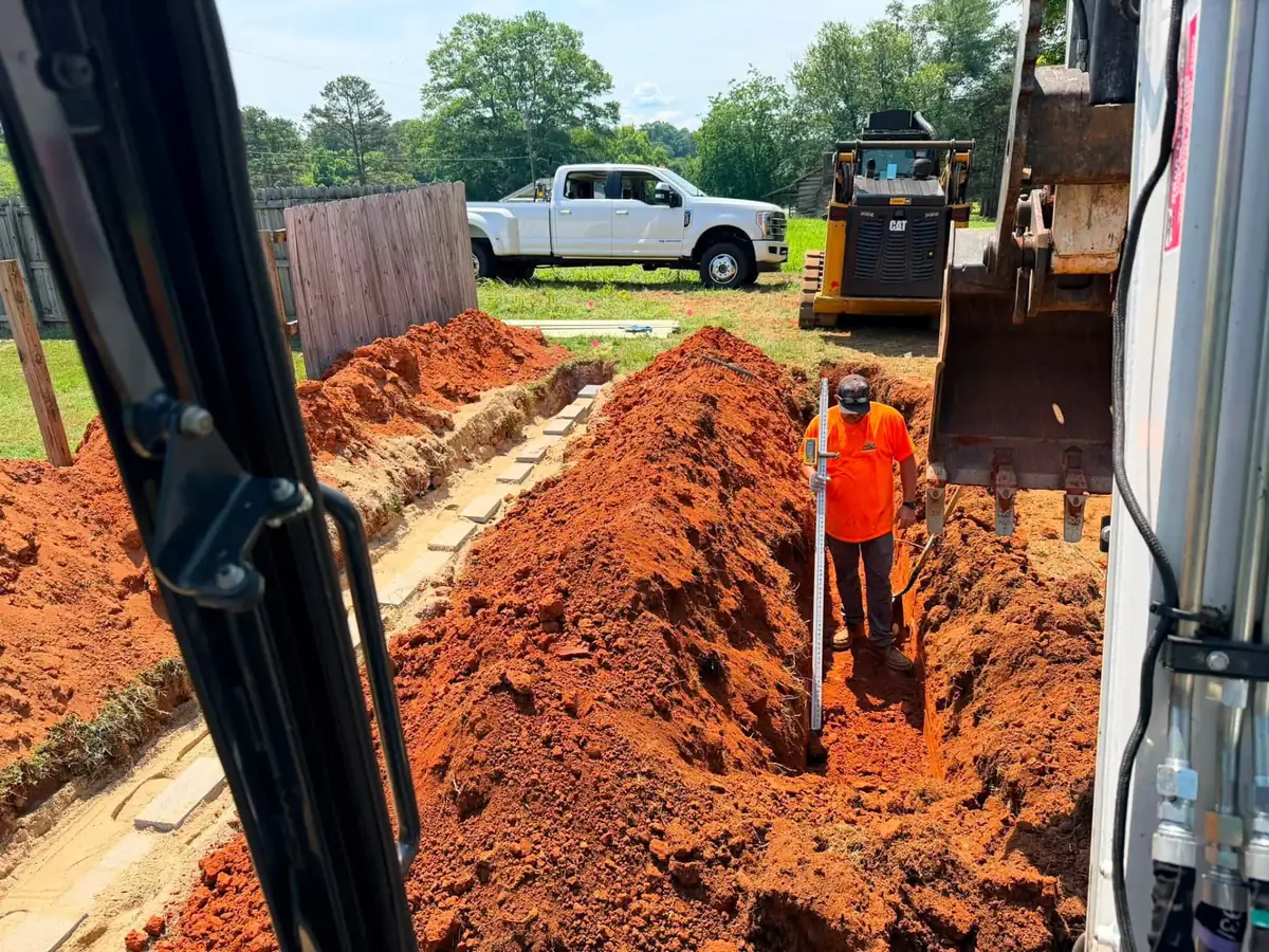 Checking trench depth during a septic system installation near Shelby, NC